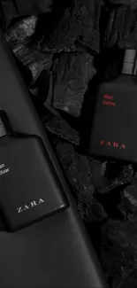 Elegant black fragrance bottles on dark texture.