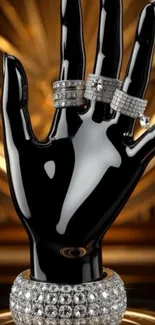 Black mannequin hand with diamond rings in luxury setting.
