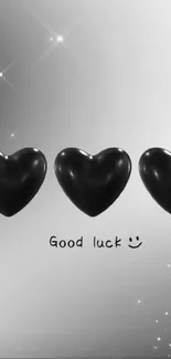 Elegant black hearts wallpaper with good luck message.