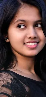 Portrait of a smiling woman with black lace top.