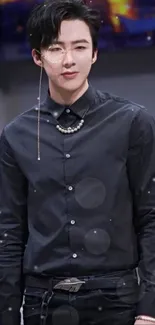 Man in elegant black shirt with stylish accessories.