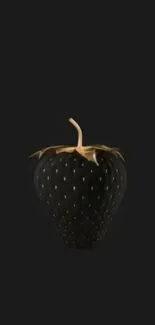 Stylish black strawberry with gold on dark background.