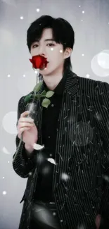 Person in black pinstripe suit with a red rose.