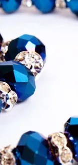 Elegant blue crystal beads wallpaper for mobile devices.