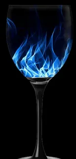 Elegant glass with blue flames on black background.