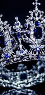 Exquisite silver crown with blue gemstones on a dark background.