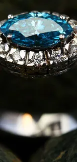 Close-up of a blue gemstone ring with sparkling diamonds on stones.