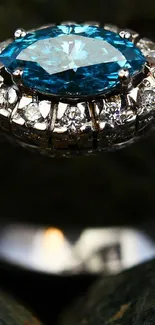 Elegant blue gemstone ring with sparkling diamonds on a dark background.