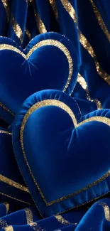 Blue hearts with gold accents on velvet texture.