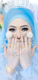 Elegant blue hijab and gold jewelry in a glamorous portrait.