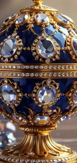 Luxurious blue jeweled egg with gold accents and gems.