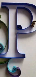 Elegant blue letter P with decorative swirls on textured background.