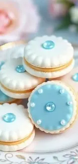 Elegant blue-frosted macarons on a decorative plate.