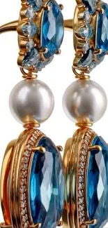 Elegant blue gemstone and pearl earrings displayed beautifully.