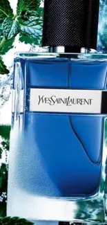 Elegant blue perfume bottle with green leaves backdrop.