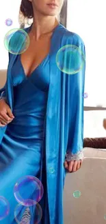 A woman in a blue silky robe with floating bubbles, exuding elegance.