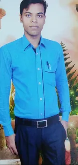 Man in blue shirt with floral background.