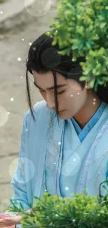 Elegant portrait in blue traditional attire amidst green foliage.