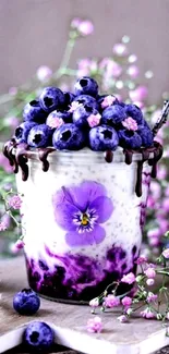 Blueberry dessert with purple flowers on a wooden table.