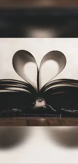 Artistic mobile wallpaper featuring a book with heart-shaped pages.