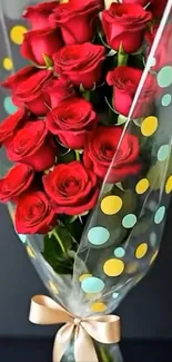 Bouquet of red roses wrapped in polka dot cellophane.