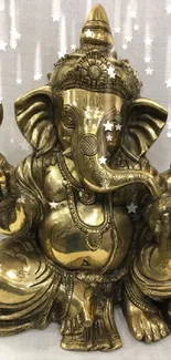 Brass Ganesha idol with intricate design on a light background.