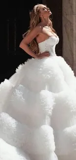 Woman in luxurious white bridal gown with elegant design.