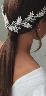 Elegant hairstyle with white ornamental accessory.