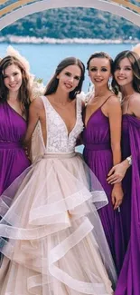 Bridal party in elegant dresses by a lake.