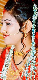 Elegant bride in red and gold attire, showcasing traditional jewelry and flowers.