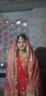 Traditional bride in red attire with intricate design.