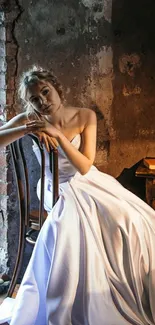 Bride in white gown sitting in rustic room with natural light.