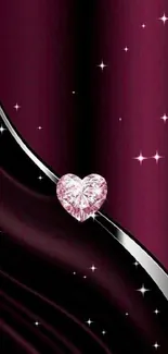 Burgundy wallpaper with heart-shaped gemstone and sleek design.