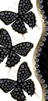 Elegant black butterflies with jewels and gold accents on mobile wallpaper.