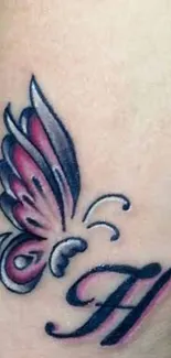 Intricate butterfly tattoo with pink wings and black detailing on warm beige skin.