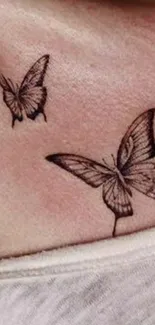 Elegant tattoo of two butterflies on skin.