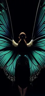 Woman with teal green butterfly wings on black background.