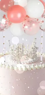 A pink cake with a crown and balloons, perfect for a birthday celebration.