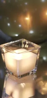 A candle with golden orbs creating a warm, elegant scene.