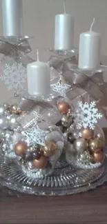 Elegant centerpiece with candles and ornaments on a glass plate.