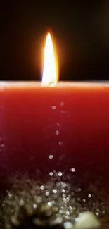 Serene red candle wallpaper with glowing flame.