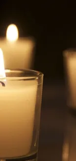 Serene candlelight in elegant glass votives glowing softly in the dark.