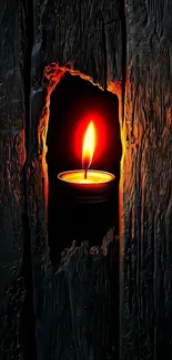 Glowing candle in rustic wooden wall.