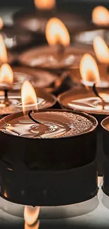 Multiple glowing candles creating a warm and tranquil atmosphere for phone display.
