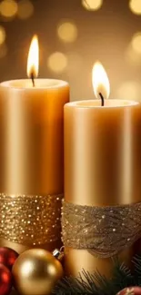 Elegant golden candles with festive Christmas decorations.