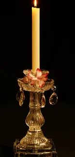 Luminous candle on a crystal holder, exuding warmth and elegance against a black backdrop.