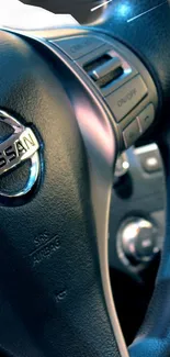 Close-up of a car steering wheel with metallic details and logo.