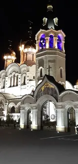 Beautifully lit cathedral at night with domes and intricate architecture.