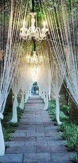 Chandelier-lit path with white drapes and lush greenery creating a romantic ambiance.