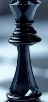 Black chess king piece on chessboard with blurred background.